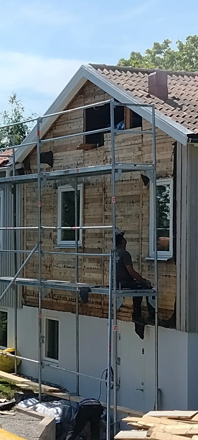 Fasadbyte med mörk panel före arbetet